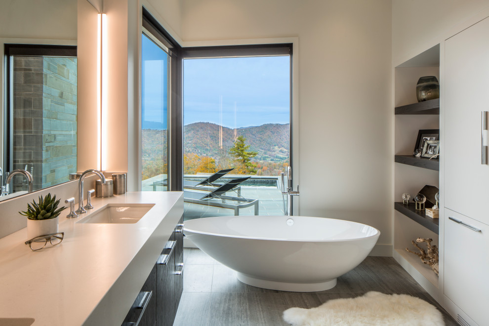 Mid-sized minimalist master white tile and porcelain tile limestone floor and gray floor bathroom photo in Other with flat-panel cabinets, dark wood cabinets, a one-piece toilet, white walls, an undermount sink, quartz countertops, a hinged shower door and white countertops