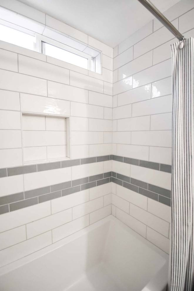 This is an example of a small modern shower room bathroom in Portland with flat-panel cabinets, light wood cabinets, a shower/bath combination, a two-piece toilet, white tiles, metro tiles, beige walls, cork flooring, a submerged sink, engineered stone worktops, red floors, a shower curtain, white worktops, a wall niche, a single sink and a built in vanity unit.