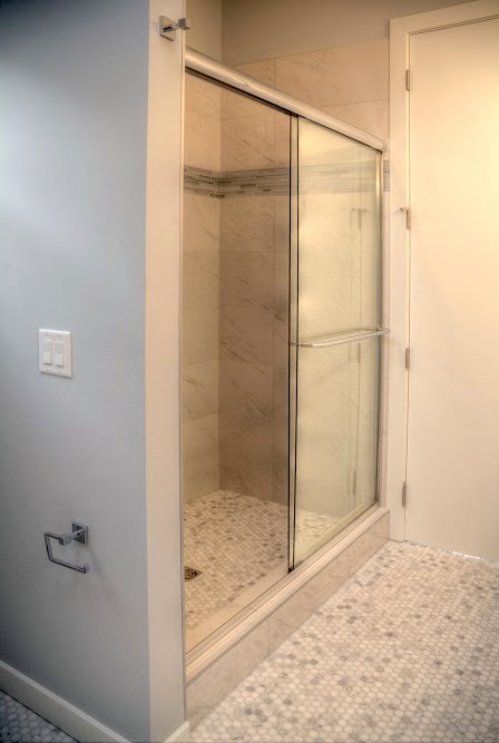 This is an example of a large traditional ensuite bathroom in Calgary with a submerged sink, flat-panel cabinets, white cabinets, quartz worktops, a freestanding bath, an alcove shower, a two-piece toilet, multi-coloured tiles, mosaic tiles, blue walls and mosaic tile flooring.