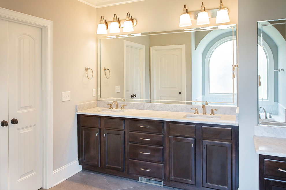 Bathroom - traditional master bathroom idea in Other with an undermount sink, brown cabinets and marble countertops