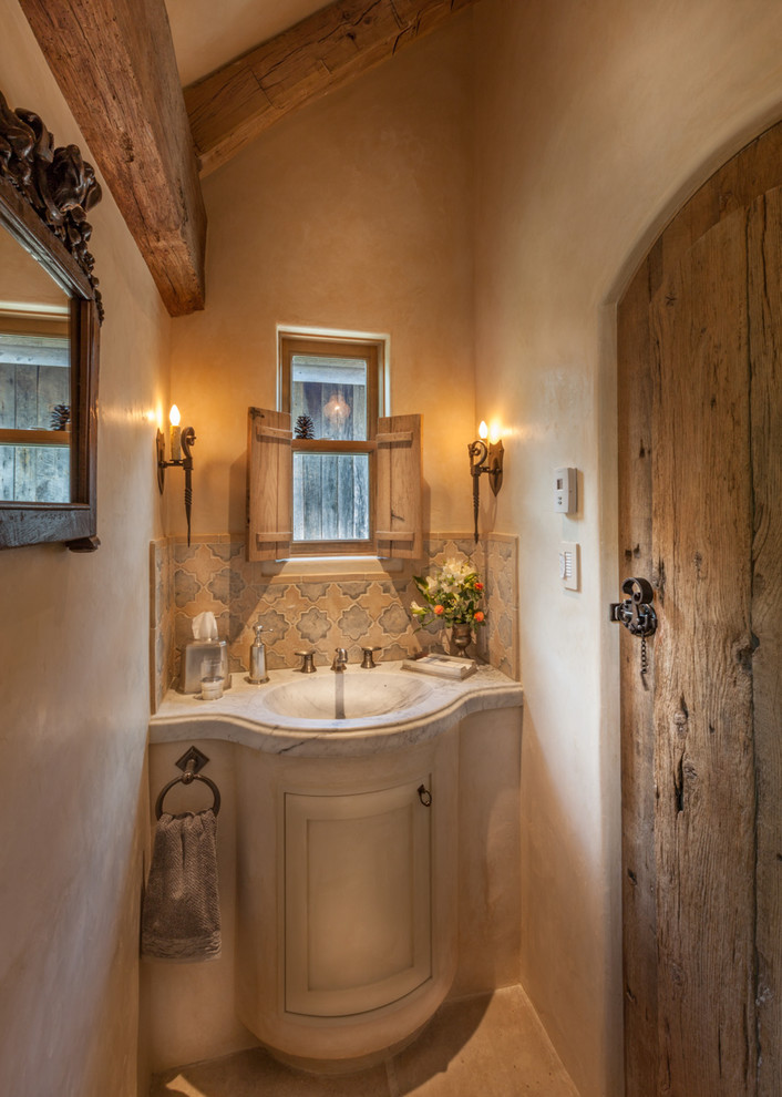 This is an example of a small traditional bathroom in Denver with beige cabinets, marble worktops, beige walls, an integrated sink, raised-panel cabinets, beige tiles and slate flooring.