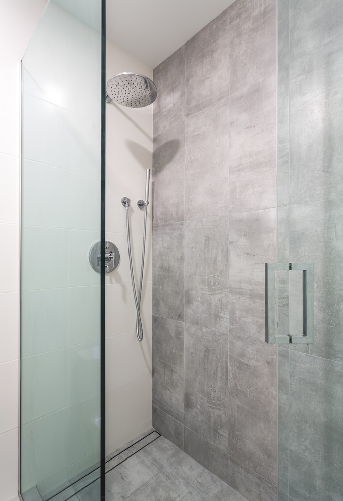 Inspiration for a mid-sized contemporary master multicolored tile and marble tile tub/shower combo remodel in Chicago with a hinged shower door, flat-panel cabinets, medium tone wood cabinets, an undermount sink, quartz countertops, white countertops, a one-piece toilet and beige walls