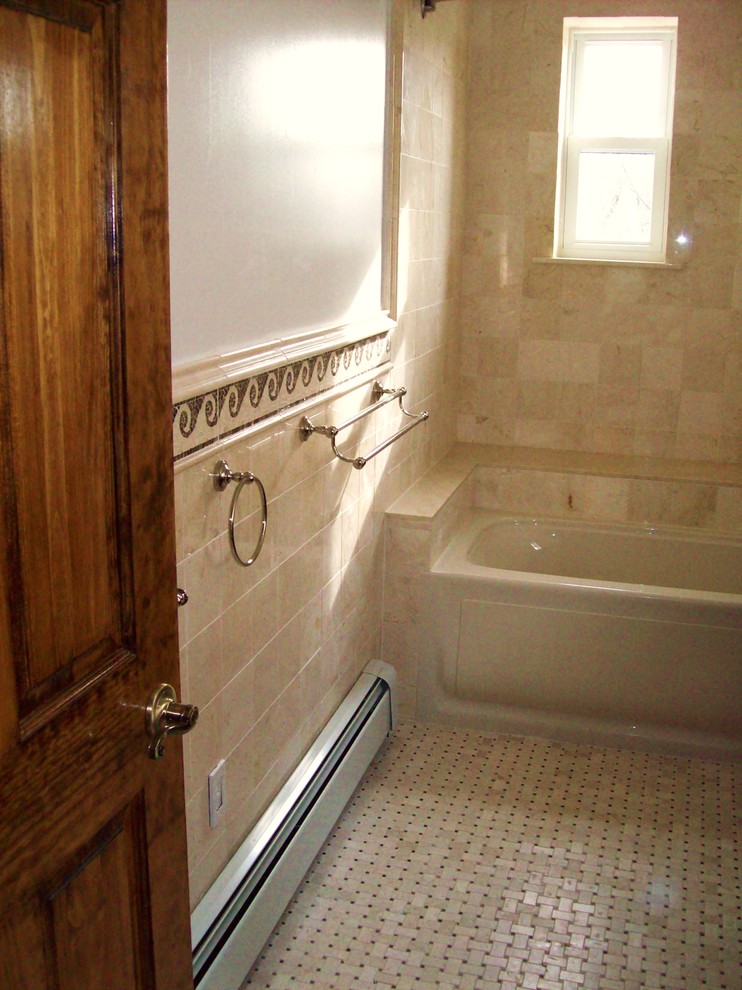 Example of a mid-sized classic master beige tile and stone tile tub/shower combo design in New York with furniture-like cabinets, dark wood cabinets, a hot tub, a one-piece toilet, white walls, an undermount sink and marble countertops