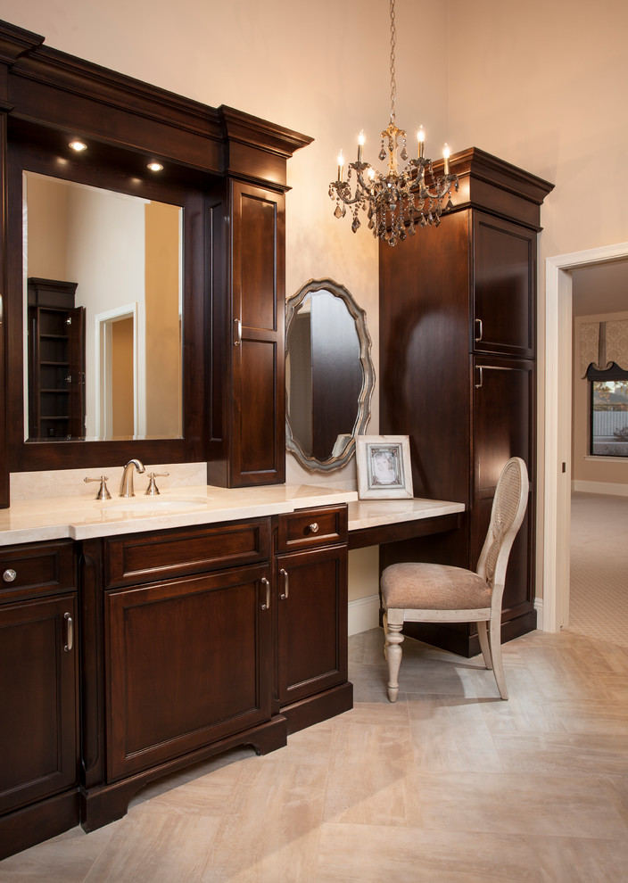 Bathroom - large traditional master bathroom idea in Phoenix with recessed-panel cabinets, dark wood cabinets, beige walls, an integrated sink and quartzite countertops