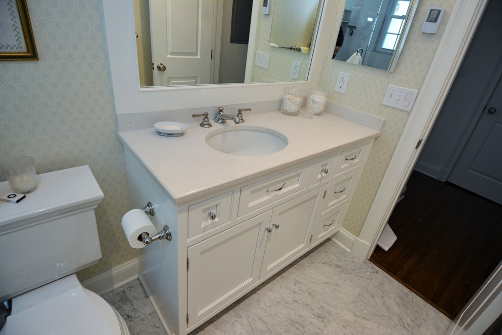 Example of a small classic master ceramic tile bathroom design in New York with a wall-mount sink, recessed-panel cabinets, white cabinets, quartz countertops, a two-piece toilet and white walls
