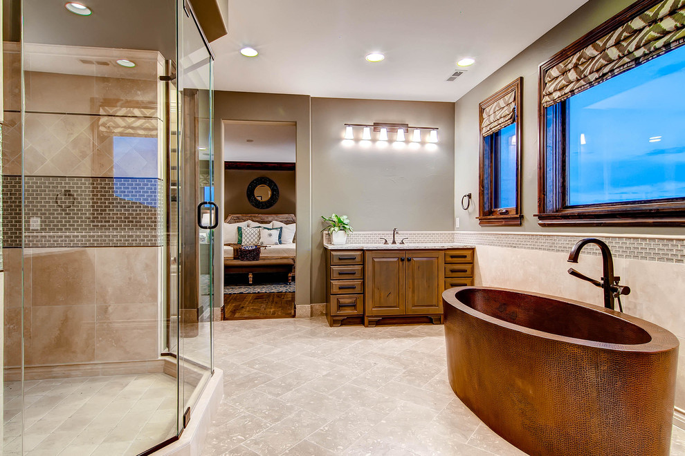 Cette photo montre une grande salle de bain principale chic en bois brun avec un plan de toilette en granite, une baignoire indépendante, une douche d'angle, un sol en calcaire et un placard avec porte à panneau surélevé.