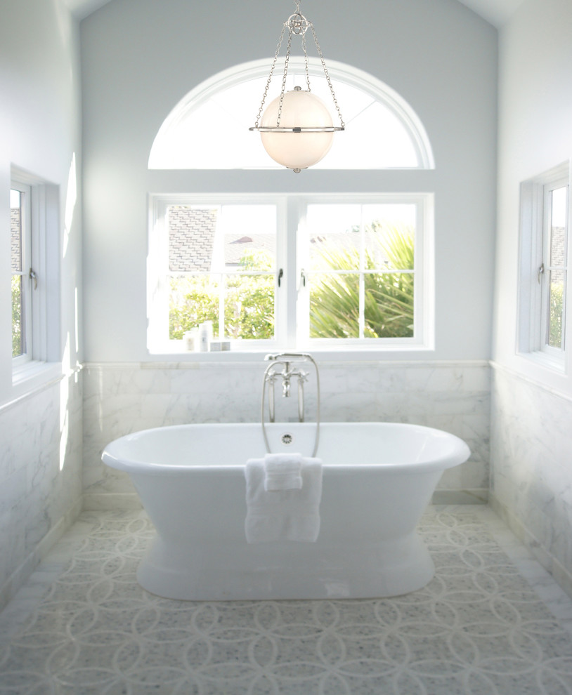 Example of a large classic master mosaic tile floor and gray floor freestanding bathtub design in Austin with white walls