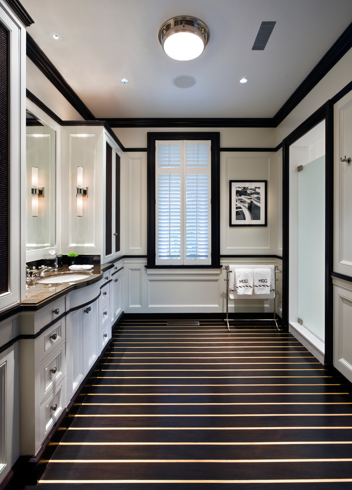 Elegant bathroom photo in New York with an undermount sink, recessed-panel cabinets and white cabinets