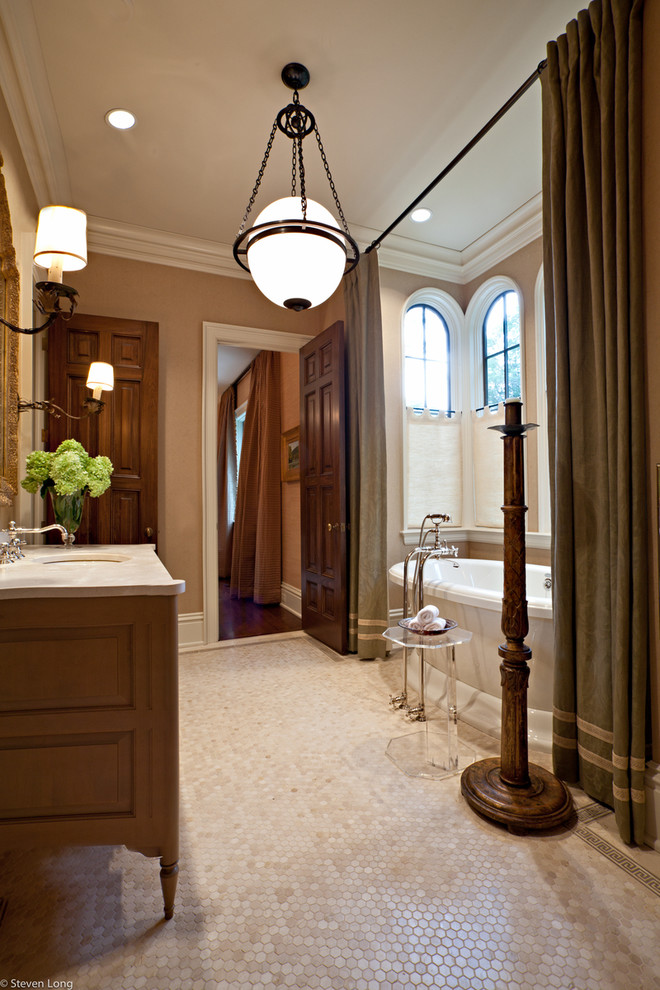 This is an example of a traditional bathroom in Nashville with a freestanding bath and feature lighting.