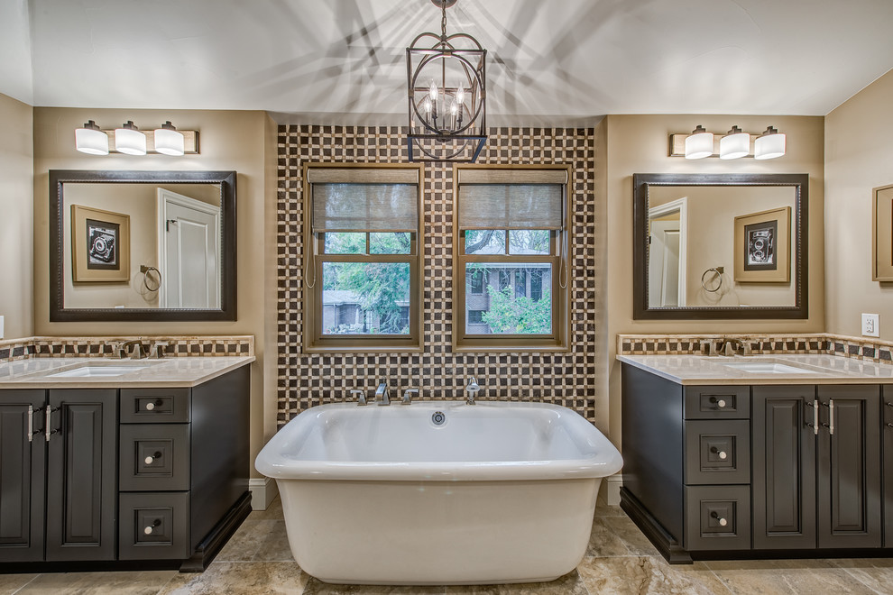 Freestanding bathtub - traditional ceramic tile porcelain tile freestanding bathtub idea in Denver with raised-panel cabinets, beige walls, an undermount sink and dark wood cabinets