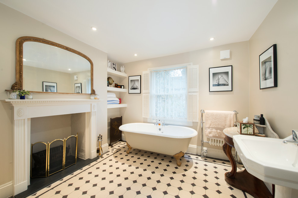 Medium sized victorian family bathroom in London with a claw-foot bath, a shower/bath combination, black and white tiles and ceramic flooring.