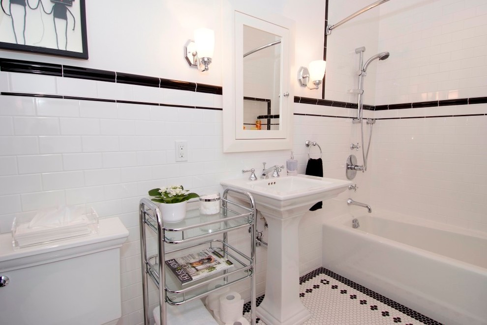 Exempel på ett stort klassiskt badrum för barn, med ett piedestal handfat, luckor med infälld panel, vita skåp, ett badkar i en alkov, en dusch/badkar-kombination, en toalettstol med separat cisternkåpa, vit kakel, keramikplattor, vita väggar och klinkergolv i keramik
