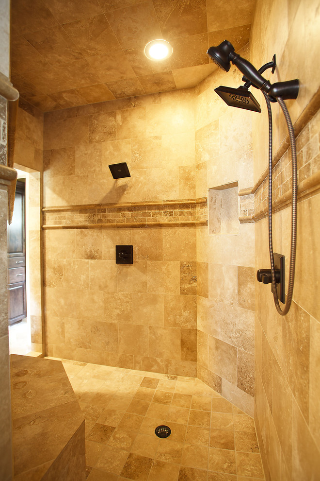 Large traditional ensuite bathroom in Houston with a double shower, beige tiles, stone tiles and travertine flooring.