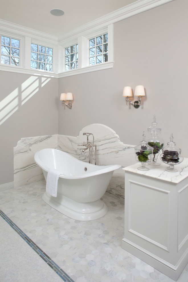 This is an example of a classic bathroom in Minneapolis with white cabinets, a freestanding bath and white tiles.