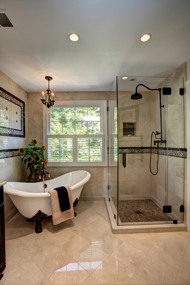 Medium sized classic ensuite bathroom in DC Metro with a claw-foot bath, a corner shower, beige tiles, limestone tiles, beige walls and limestone flooring.