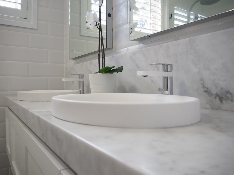 Inspiration for a medium sized contemporary ensuite bathroom in Sydney with shaker cabinets, white cabinets, a corner shower, white tiles, metro tiles, white walls, marble flooring, an integrated sink, marble worktops and a hinged door.