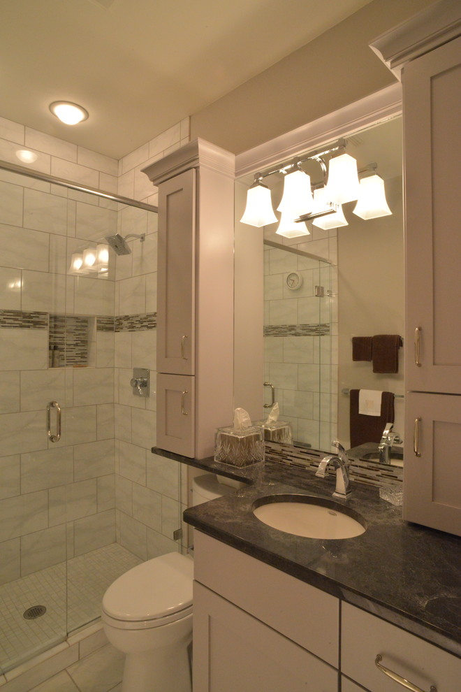Inspiration for a small traditional ensuite bathroom in Denver with a submerged sink, recessed-panel cabinets, grey cabinets, an alcove shower, a one-piece toilet, white tiles, matchstick tiles and brown walls.