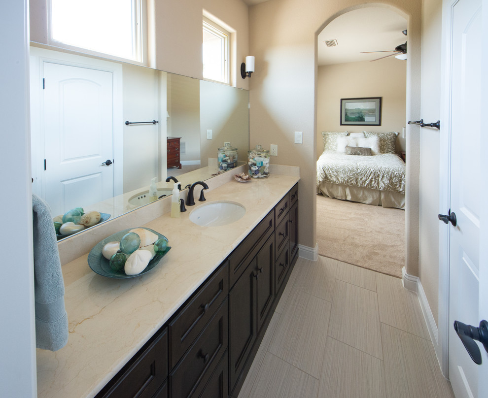 Esempio di una stanza da bagno padronale tradizionale di medie dimensioni con pareti beige, pavimento con piastrelle in ceramica, ante con riquadro incassato, ante in legno bruno, lavabo sottopiano e pavimento beige