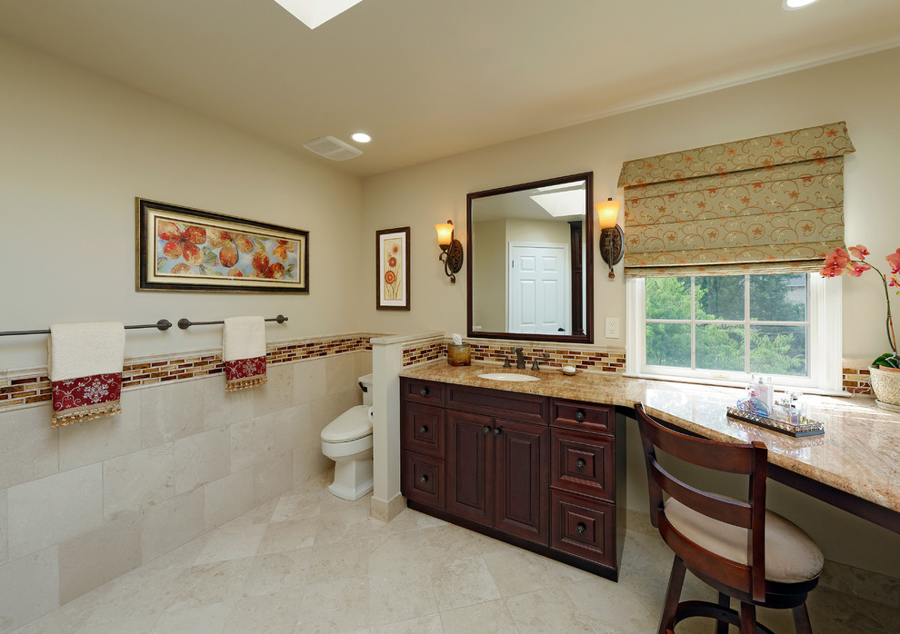 Inspiration for a mid-sized timeless master multicolored tile and stone tile marble floor corner shower remodel in DC Metro with an undermount sink, raised-panel cabinets, dark wood cabinets, granite countertops, a one-piece toilet and beige walls