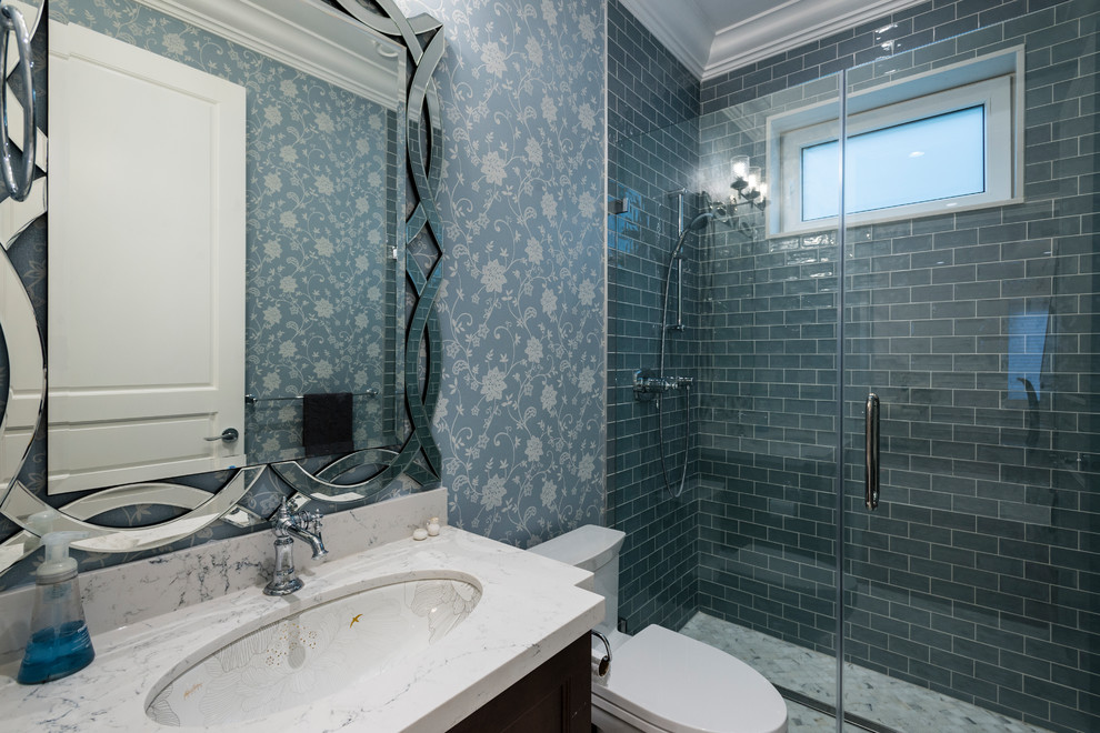 Small classic shower room bathroom in Vancouver with recessed-panel cabinets, black cabinets, an alcove shower, a one-piece toilet, blue tiles, glass tiles, blue walls, porcelain flooring, a submerged sink, engineered stone worktops, multi-coloured floors and a hinged door.