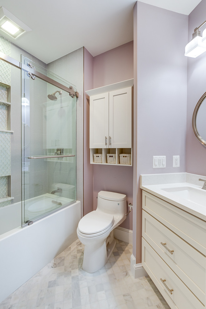 Photo of a small classic shower room bathroom in DC Metro with shaker cabinets, white cabinets, an alcove bath, an alcove shower, a one-piece toilet, grey tiles, porcelain tiles, purple walls, marble flooring, a submerged sink, quartz worktops, grey floors, a sliding door and white worktops.