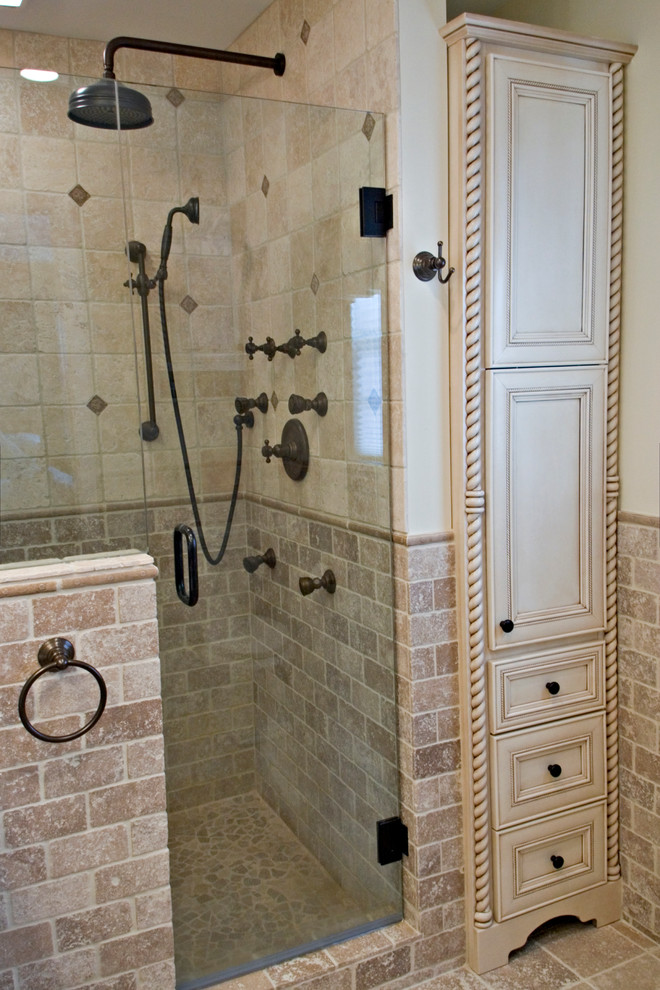 Small mediterranean ensuite bathroom in Bridgeport with a submerged sink, freestanding cabinets, white cabinets, granite worktops, an alcove shower, beige tiles, stone tiles, beige walls and travertine flooring.