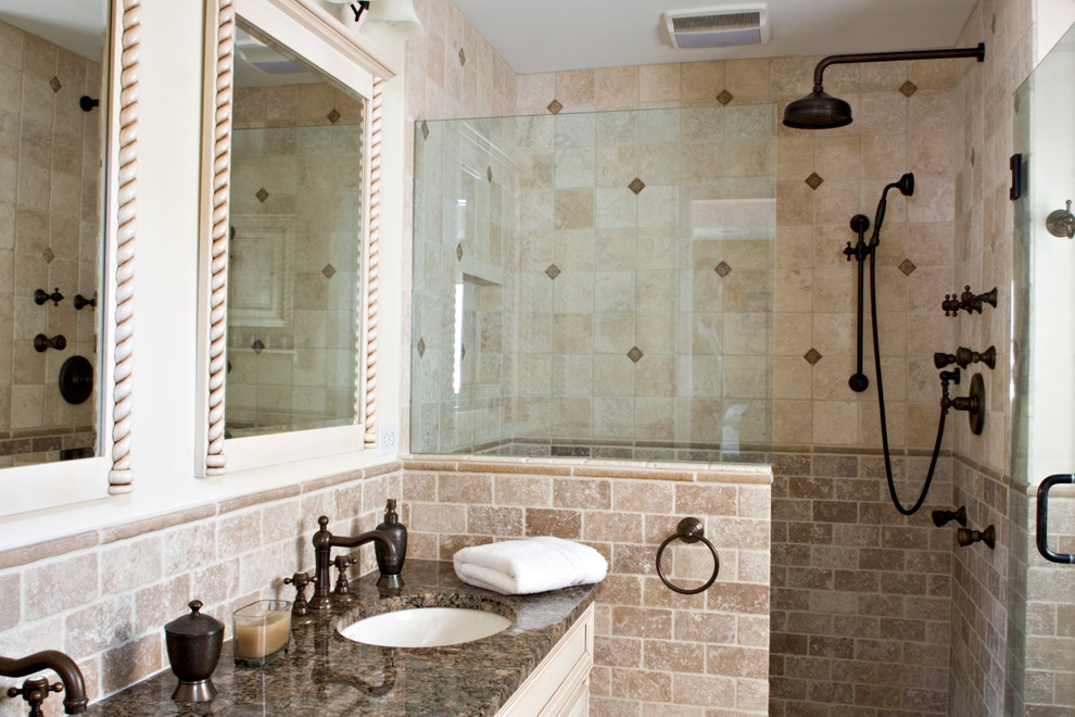 Inspiration for a small mediterranean ensuite bathroom in Bridgeport with a submerged sink, freestanding cabinets, white cabinets, granite worktops, an alcove shower, a two-piece toilet, beige tiles, stone tiles, beige walls and travertine flooring.