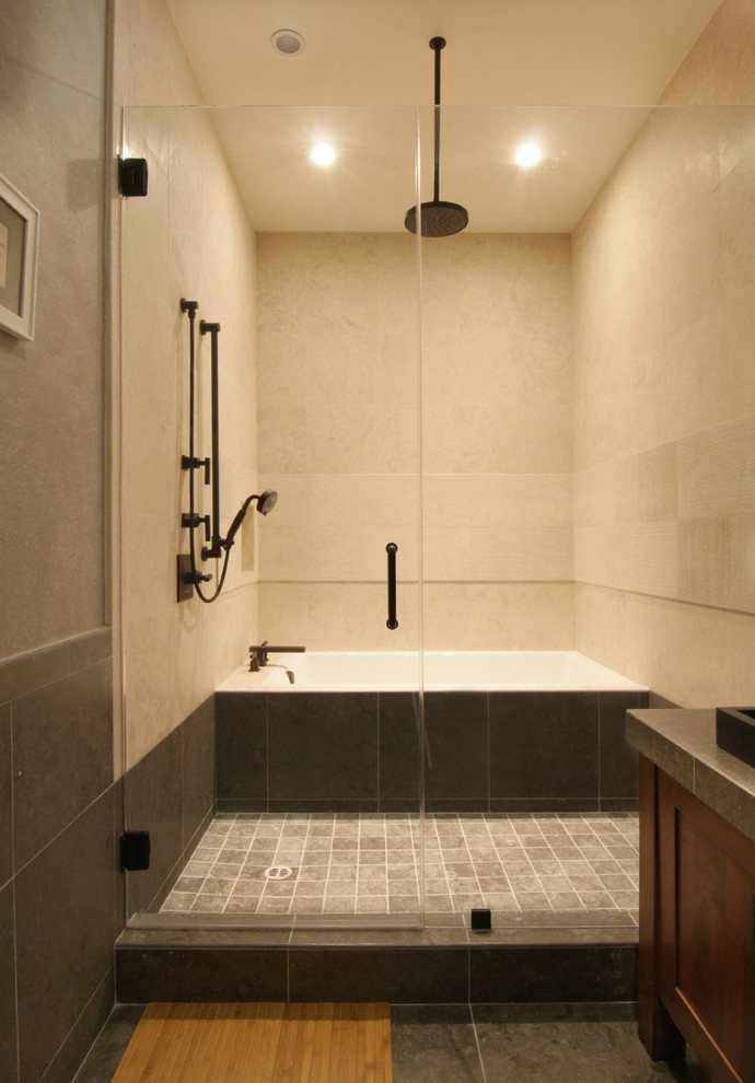 Mid-sized asian 3/4 beige tile and stone tile marble floor bathroom photo in Los Angeles with recessed-panel cabinets, dark wood cabinets, brown walls, a vessel sink and marble countertops