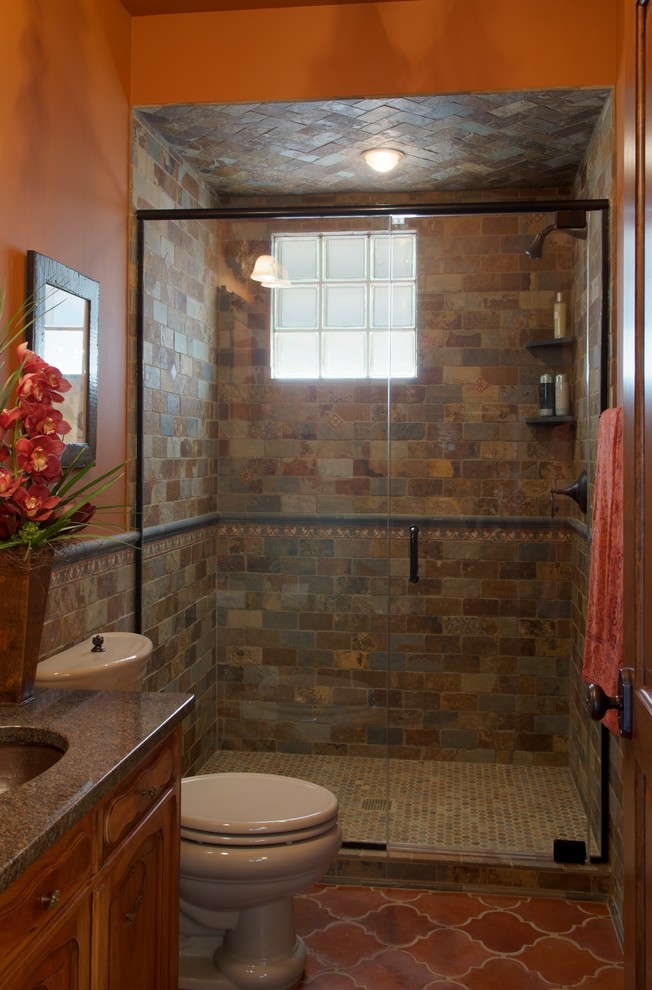 Design ideas for a medium sized traditional shower room bathroom in Minneapolis with a submerged sink, white tiles, freestanding cabinets, medium wood cabinets, granite worktops, a built-in shower, a two-piece toilet, ceramic tiles, orange walls and terracotta flooring.