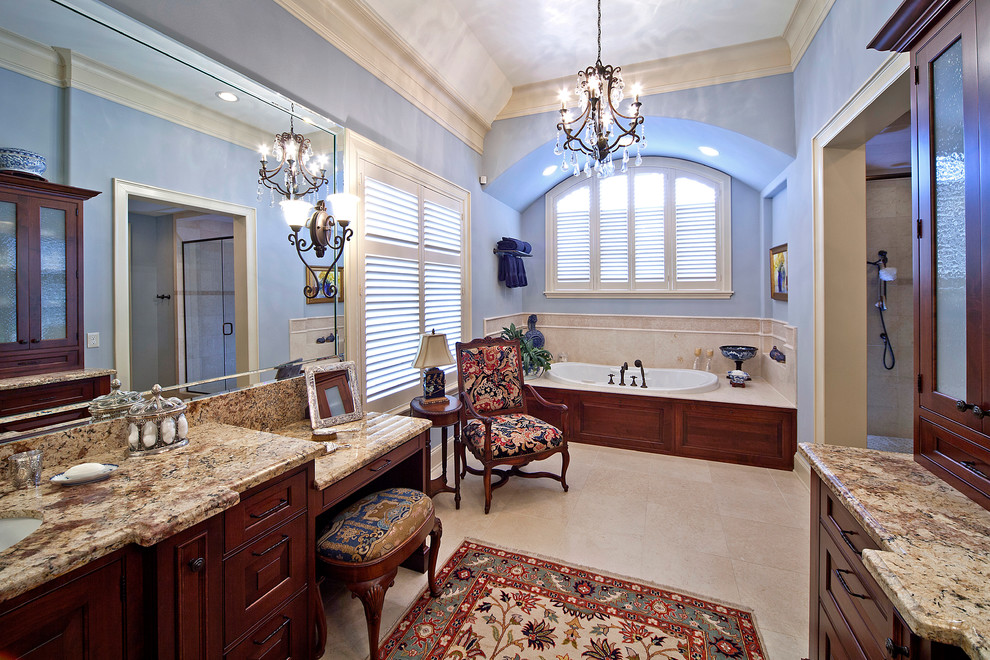Imagen de cuarto de baño principal clásico grande con lavabo bajoencimera, armarios con paneles con relieve, encimera de granito, bañera encastrada, puertas de armario marrones, ducha empotrada, paredes azules y suelo blanco