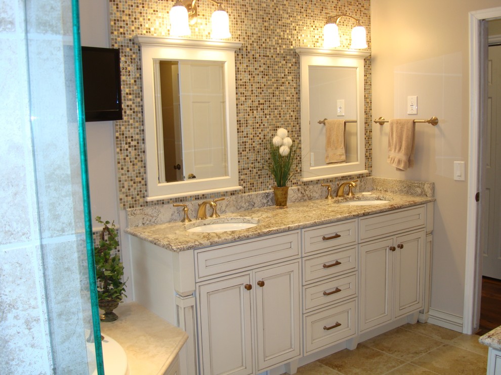 Example of a mid-sized classic master beige tile and stone tile porcelain tile bathroom design in Salt Lake City with an undermount sink, recessed-panel cabinets, white cabinets, granite countertops, a two-piece toilet and white walls