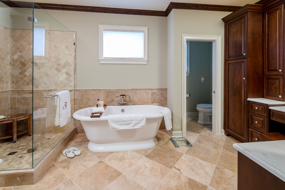 Example of a mid-sized classic master travertine floor bathroom design in Atlanta with raised-panel cabinets, medium tone wood cabinets, a two-piece toilet, beige walls, an undermount sink and quartz countertops