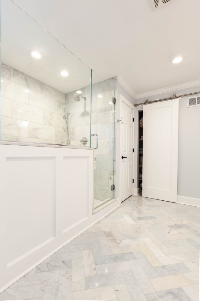 Design ideas for a large classic ensuite bathroom in Chicago with beaded cabinets, white cabinets, a freestanding bath, a corner shower, grey tiles, grey walls, marble flooring, a submerged sink, engineered stone worktops, grey floors, a hinged door, white worktops, a shower bench, double sinks, a freestanding vanity unit and wainscoting.