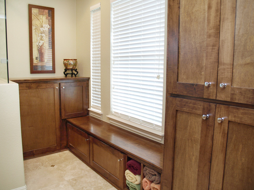 Example of a large classic master multicolored tile and travertine tile travertine floor drop-in bathtub design in Austin with shaker cabinets, beige walls, a vessel sink, medium tone wood cabinets and limestone countertops