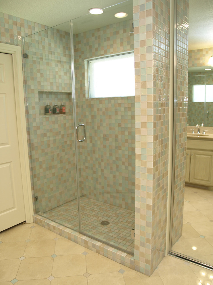 Photo of a small traditional ensuite bathroom in Austin with beige tiles, blue tiles, grey tiles, white tiles, glass tiles, a submerged sink, raised-panel cabinets, distressed cabinets, a walk-in shower, multi-coloured walls, marble flooring, marble worktops and a two-piece toilet.