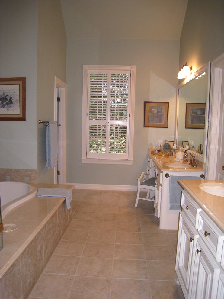 Large elegant master beige tile and porcelain tile porcelain tile drop-in bathtub photo in Austin with recessed-panel cabinets, white cabinets, blue walls, an undermount sink, a two-piece toilet and marble countertops