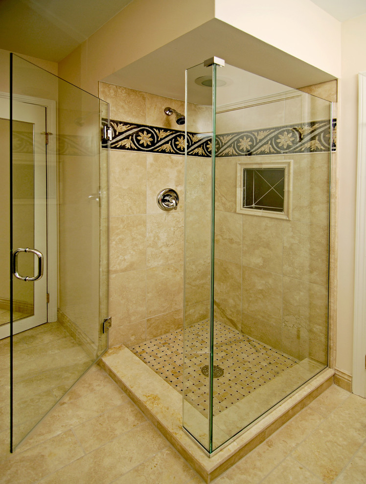 Inspiration for a medium sized mediterranean ensuite bathroom in Chicago with a vessel sink, raised-panel cabinets, black cabinets, a corner shower, a two-piece toilet, beige tiles, stone tiles, beige walls and marble flooring.