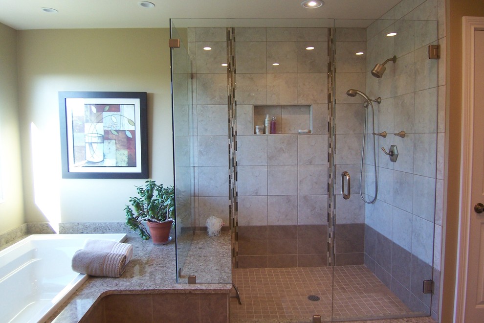 This is an example of a medium sized traditional ensuite bathroom in Cincinnati with raised-panel cabinets, dark wood cabinets, a built-in bath, a corner shower, a two-piece toilet, beige tiles, porcelain tiles, beige walls, porcelain flooring, a submerged sink and granite worktops.