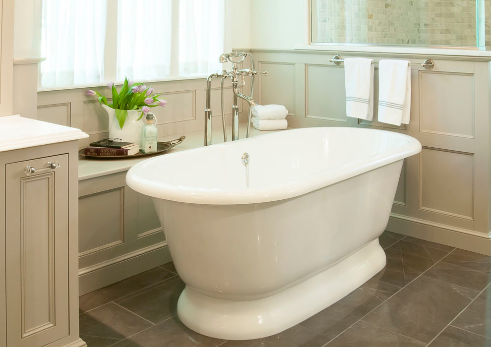 Inspiration for a large traditional ensuite bathroom in St Louis with beaded cabinets, white cabinets, a freestanding bath, a built-in shower, a two-piece toilet, grey tiles, stone tiles, white walls, porcelain flooring, a submerged sink and engineered stone worktops.