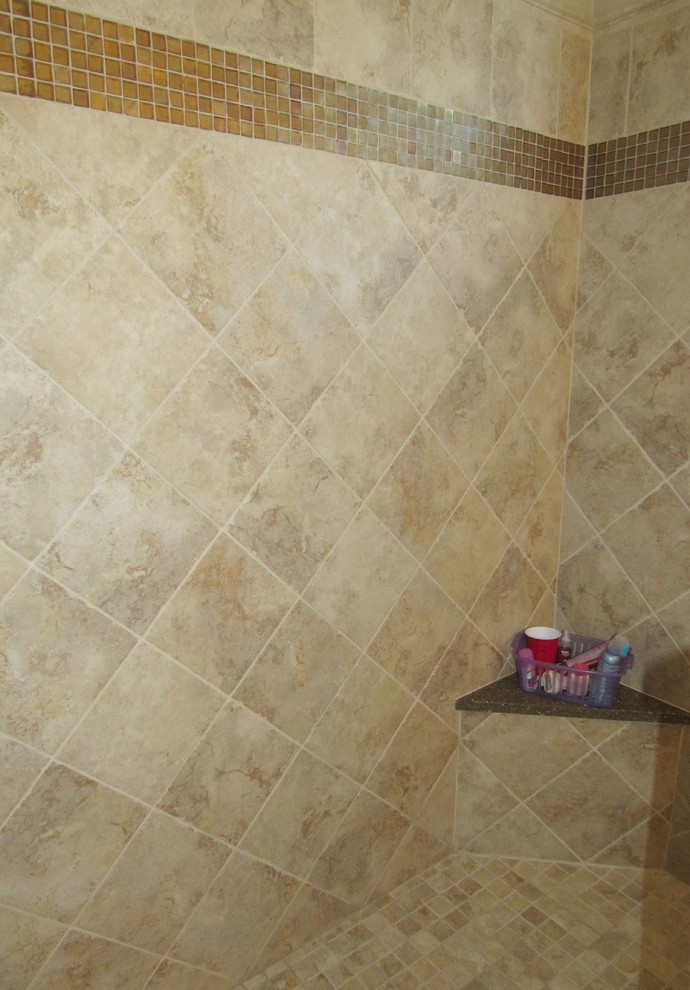 Example of a large classic master beige tile and ceramic tile ceramic tile doorless shower design in Cleveland with a drop-in sink, recessed-panel cabinets, white cabinets, solid surface countertops and beige walls