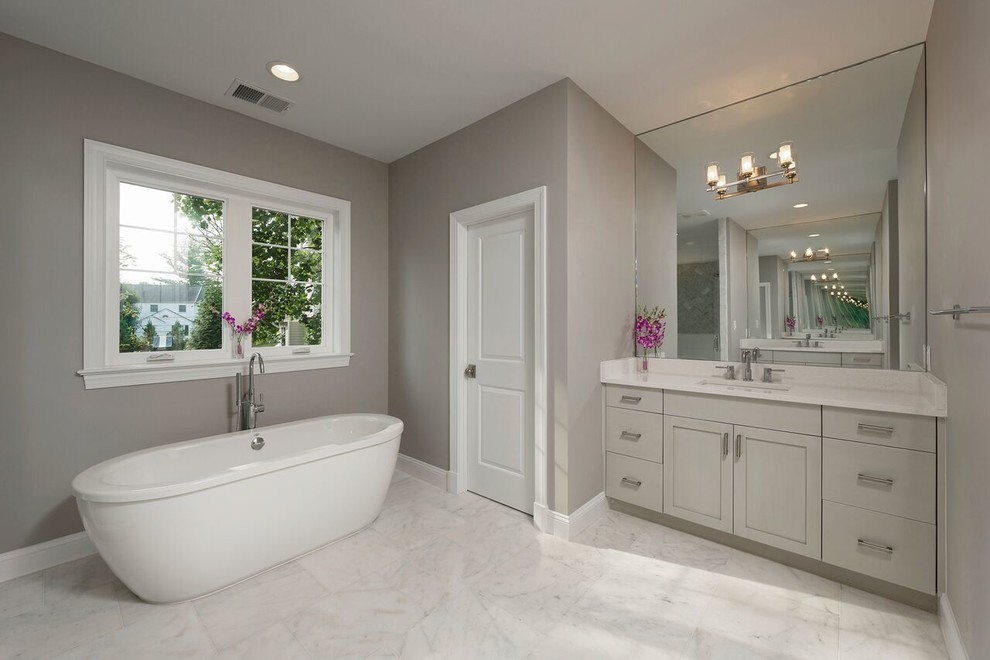 Medium sized classic shower room bathroom in DC Metro with beaded cabinets, grey cabinets, a freestanding bath, an alcove shower, a one-piece toilet, grey walls, marble flooring, a submerged sink and engineered stone worktops.