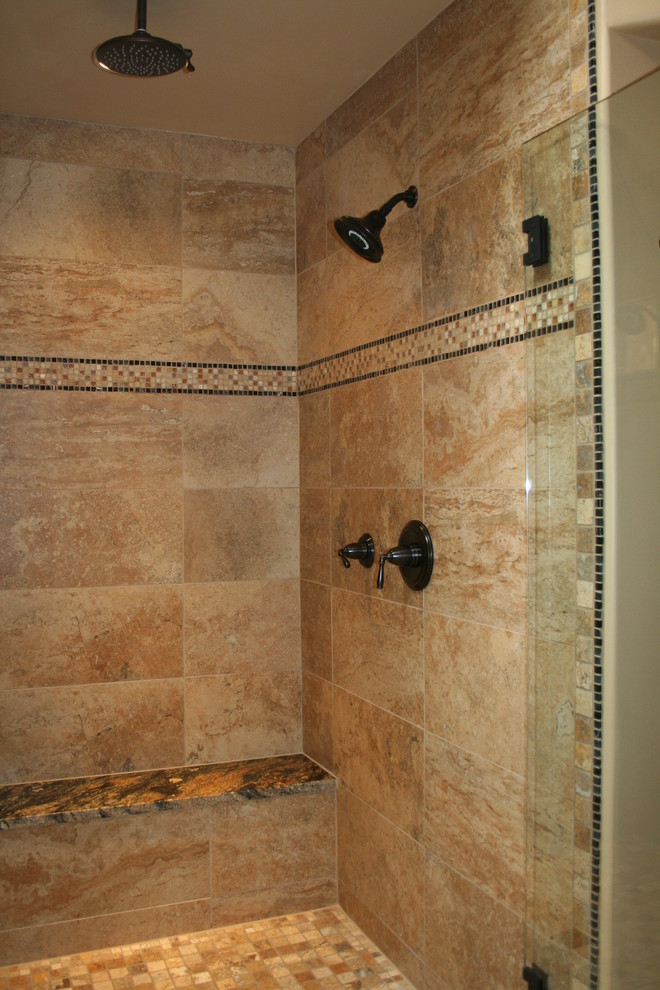 Alcove shower - mid-sized southwestern master ceramic tile and multicolored tile beige floor and ceramic tile alcove shower idea in Albuquerque with raised-panel cabinets, light wood cabinets, beige walls, an undermount sink, granite countertops and a hinged shower door