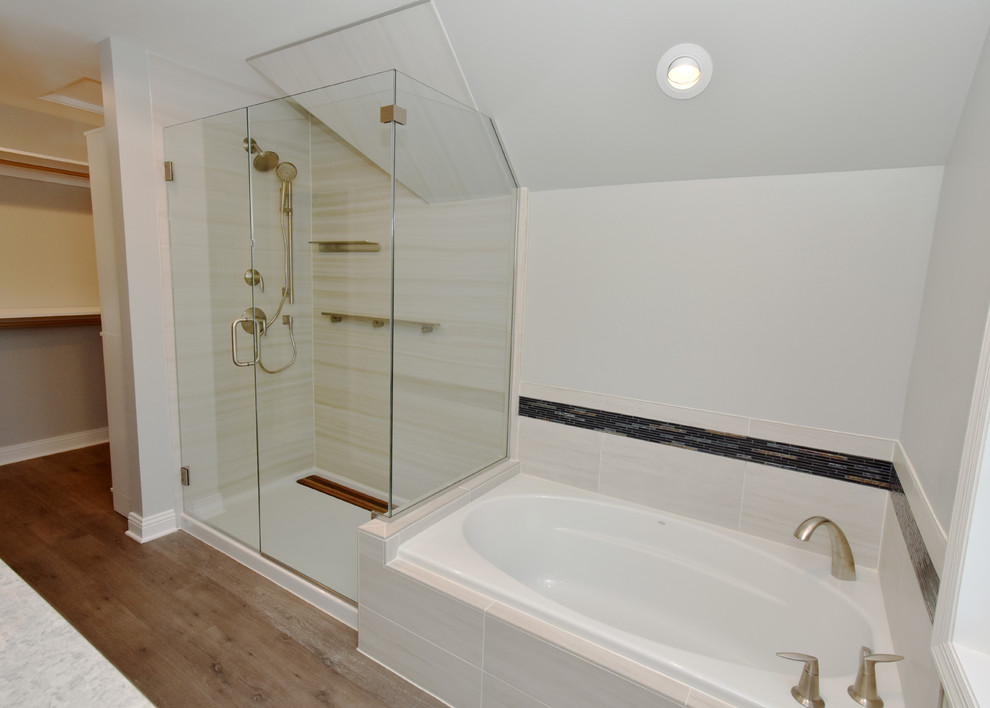 Inspiration for a large traditional ensuite bathroom in Milwaukee with shaker cabinets, white cabinets, a corner bath, a corner shower, a two-piece toilet, beige tiles, grey walls, vinyl flooring, a built-in sink, engineered stone worktops, brown floors, a hinged door and grey worktops.