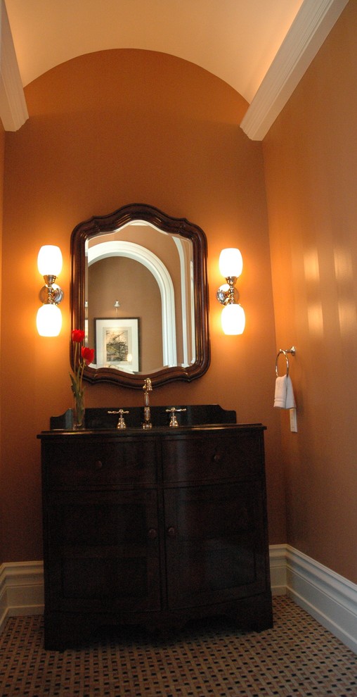 Mid-sized 1950s brown tile and subway tile marble floor bathroom photo in Milwaukee with an undermount sink, furniture-like cabinets, dark wood cabinets, granite countertops, a two-piece toilet and brown walls