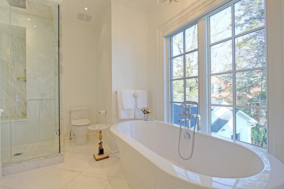 Bild på ett mellanstort vintage en-suite badrum, med ett fristående badkar, en hörndusch, en toalettstol med hel cisternkåpa, vit kakel, stenkakel, vita väggar och marmorgolv