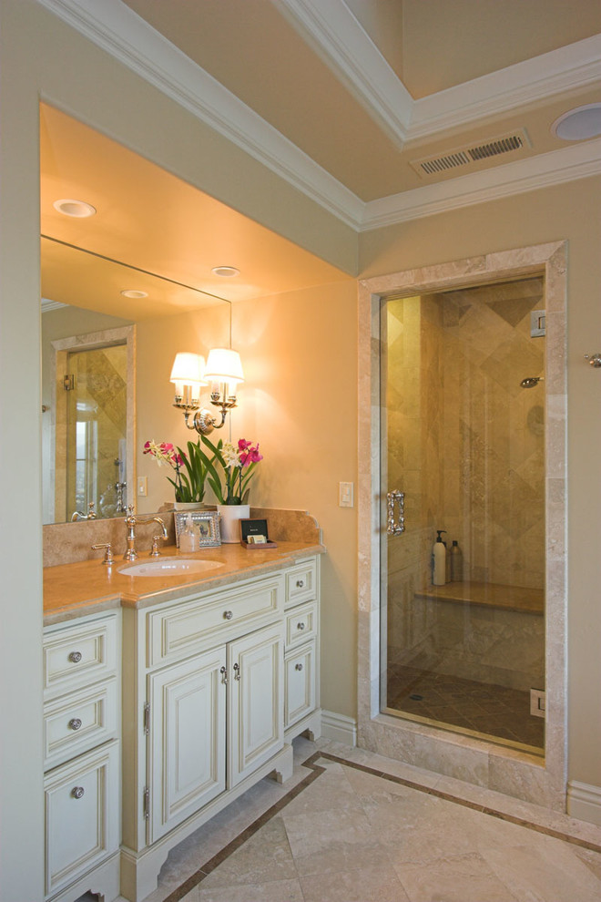 This is an example of a large traditional ensuite bathroom in San Francisco with a submerged sink, freestanding cabinets, white cabinets, granite worktops, a walk-in shower, beige tiles, ceramic tiles, beige walls and travertine flooring.