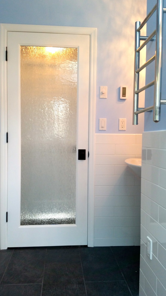 Réalisation d'une salle de bain principale tradition de taille moyenne avec un carrelage blanc, un carrelage métro, un mur bleu, un sol en carrelage de porcelaine et un lavabo suspendu.