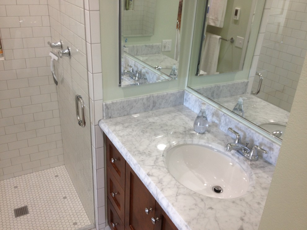 Medium sized traditional grey and white shower room bathroom in Seattle with a submerged sink, shaker cabinets, medium wood cabinets, marble worktops, an alcove shower, white tiles, ceramic tiles, green walls, porcelain flooring, a hinged door, grey worktops, a single sink and a built in vanity unit.