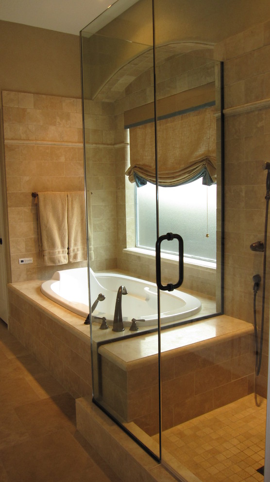 Design ideas for a classic bathroom in Houston with recessed-panel cabinets, white cabinets, a built-in bath, a one-piece toilet, beige tiles, limestone worktops, a submerged sink, beige walls and travertine flooring.
