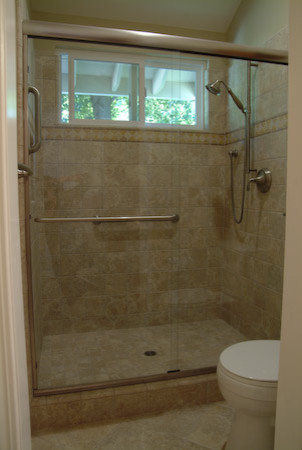 Example of a mid-sized classic master ceramic tile porcelain tile bathroom design in Sacramento with a drop-in sink, medium tone wood cabinets, tile countertops, a one-piece toilet and yellow walls